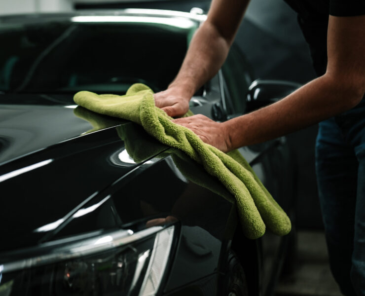 man cleans the car body with a towel. auto care man cleans the car body with a towel. auto care.