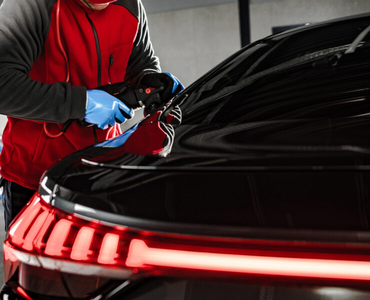 Modern Car Body Waxing and Polishing. Ceramic Coating Applying In the Professional Detailing Studio.