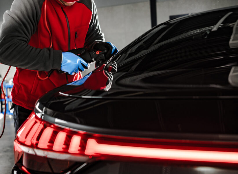 Modern Car Body Waxing and Polishing. Ceramic Coating Applying In the Professional Detailing Studio.