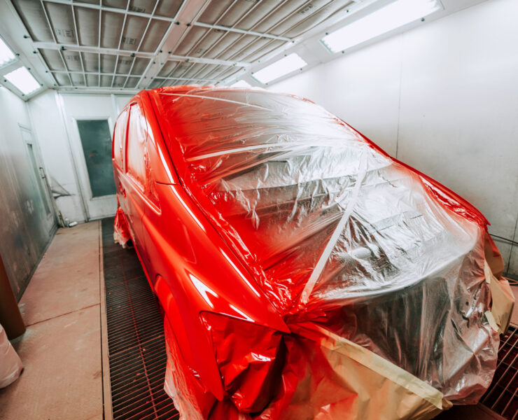Red van being paint in special paint booth, Car painting details