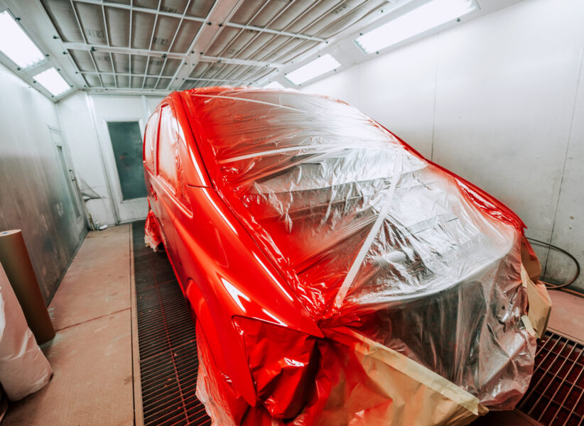 Red van being paint in special paint booth, Car painting details